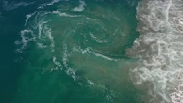 LOS CABOS MEXICO-2020: Circular Shape Forms From Waves As They Wash Back Out To