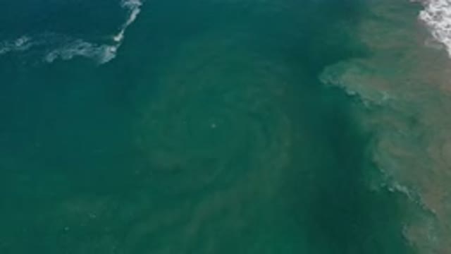 LOS CABOS MEXICO-2020: Swirling Green Eddy In Beautiful Tropical Ocean With Waves