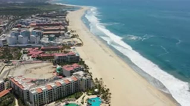 LOS CABOS MEXICO-2020: Drone View Shows Buildings Shore Sunny Beach Sand Sea