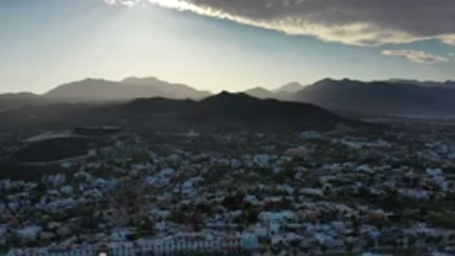 LOS CABOS MEXICO-2020: Sun Behind Clouds In The Beautiful Blue Sky Above