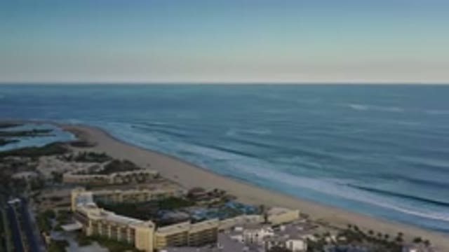 LOS CABOS MEXICO-2020: Coastal Cityscape With Buildings And Ocean Waves Under Blue Sky
