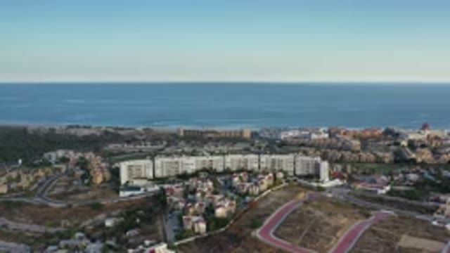LOS CABOS MEXICO-2020: Resort Near An Ocean With Hills And Various Buildings