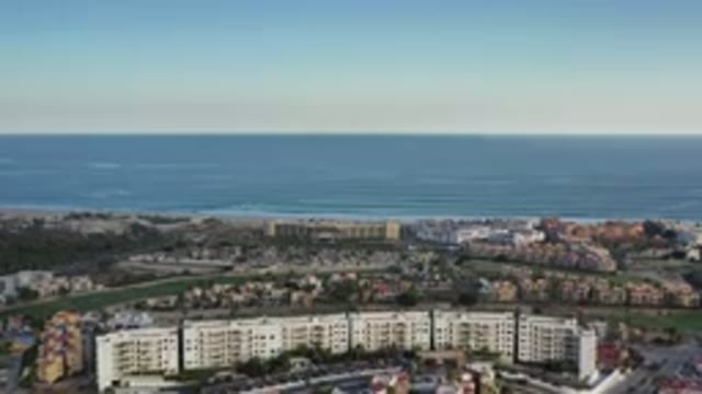 LOS CABOS MEXICO-2020: Aerial View Of A City With Buildings Houses Trees In A