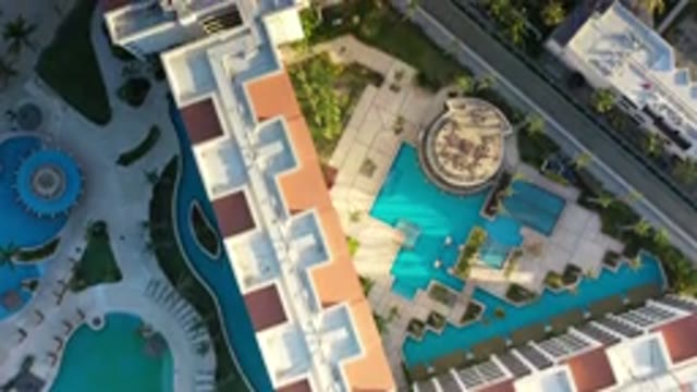 LOS CABOS MEXICO-2020: Overview Of Multilevel Resort Building Near Sand With Pools And Trees
