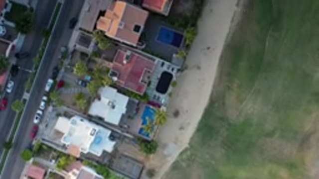 LOS CABOS MEXICO-2020: Drone Flying Above City With Roads And Cars And Buildings