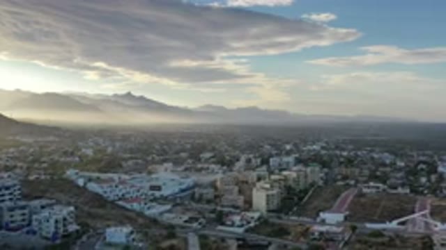 LOS CABOS MEXICO-2020: Aerial View Of A Town With Cascading Clouds Around