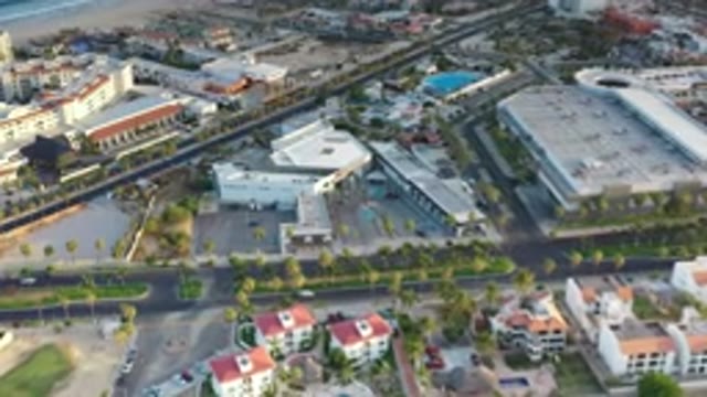 LOS CABOS MEXICO-2020: Car Driving Across The Green Street With Some Trees