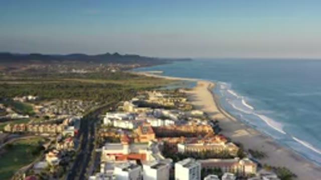 LOS CABOS MEXICO-2020: Aerial View Of City With Buildings And Waves Crashing