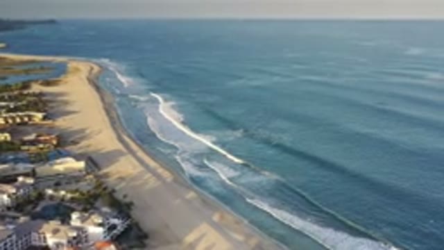 LOS CABOS MEXICO-2020: Medium Sized Waves Slowly Crashing Into The Beach Of A