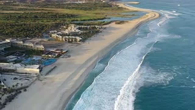 LOS CABOS MEXICO-2020: Billowing Wave Breaks From Blue Into White As It Washes Ashore