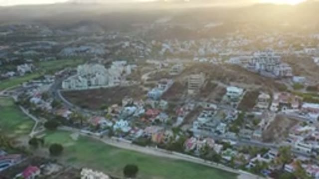 LOS CABOS MEXICO-2020: Sunset Over City Full Of Buildings And Roads With Mountains