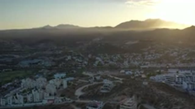 LOS CABOS MEXICO-2020: Sunlight Peers Over Mountains Of A City With Many