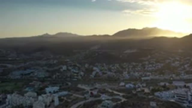 LOS CABOS MEXICO-2020: Panoramic View of Houses, Mountains, Clouds, and Sunset Sky