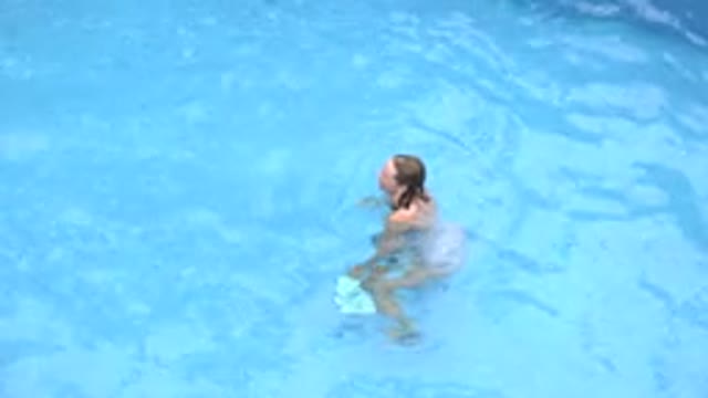LOS CABOS MEXICO-2020: Woman Swimming Alone And Having Fun In A Clean Blue Pool