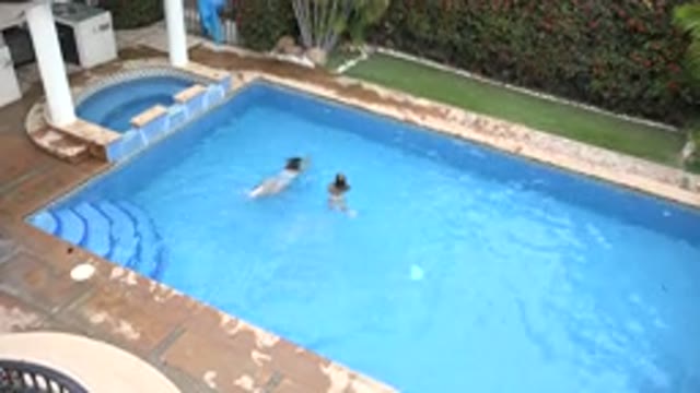 LOS CABOS MEXICO-2020: Children Playing In The Swimming Pool While Their Dog Runs