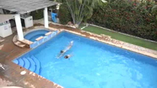 LOS CABOS MEXICO-2020: Mother And Daughter Swim In A Beautiful Blue Pool In The