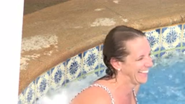 LOS CABOS MEXICO-2020: Woman At Edge Of Pool Laughing And Smiling Before