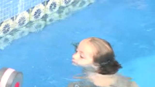 LOS CABOS MEXICO-2020: Little Child Swims In A Pool And Grabs A Floating Weight