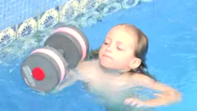 LOS CABOS MEXICO-2020: A Beautiful Little Girl Trying To Learn To Swim In The