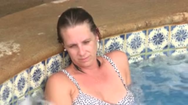 LOS CABOS MEXICO-2020: Woman Wearing Blue Speckled Bikini in Hot Tub Relaxing