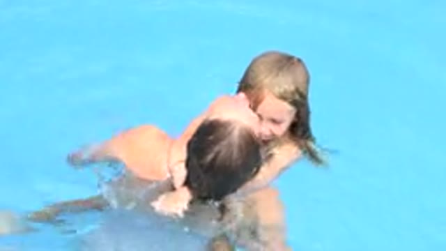 LOS CABOS MEXICO-2020: A Woman And A Baby Girl Talking And Laughing While Swimming