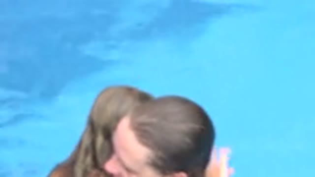 LOS CABOS MEXICO-2020: Mother Holding Daughter As They Come Out Of The Water