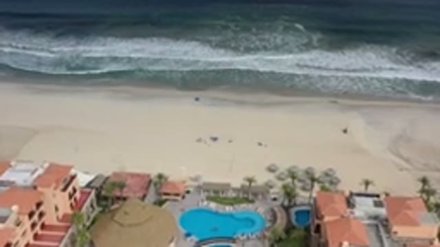 LOS CABOS MEXICO-2020: Some Houses And Some Small Waves Of A Sea On A Beach On A