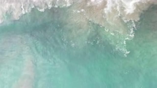 LOS CABOS MEXICO-2020: Light Green Seawater Crashes Into White Foamy Waves