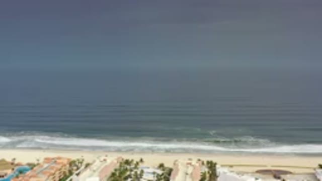 LOS CABOS MEXICO-2020: Hazy Gray View Over Dark Ocean Water As Waves Crash Onto