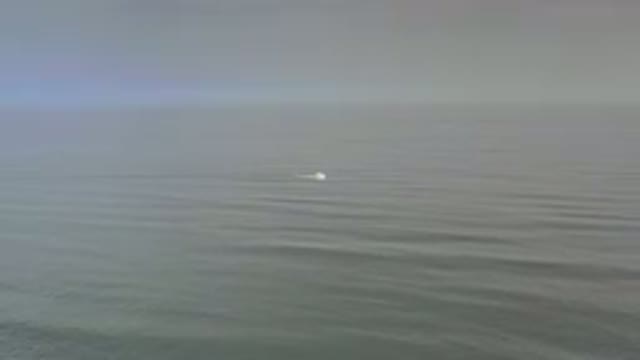 LOS CABOS MEXICO-2020: Calm Waves On A Cloudy Day With A White Object Floating