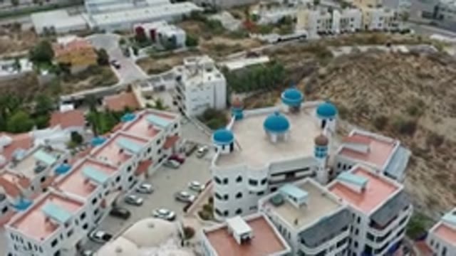 LOS CABOS MEXICO-2020: Cars Parked In A Parking Of A Building With Beautiful Roofs