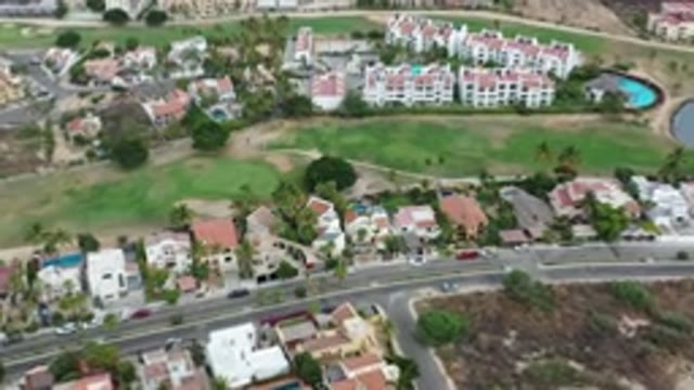 LOS CABOS MEXICO-2020: City With Big Buildings And Cars Parked Next To Green