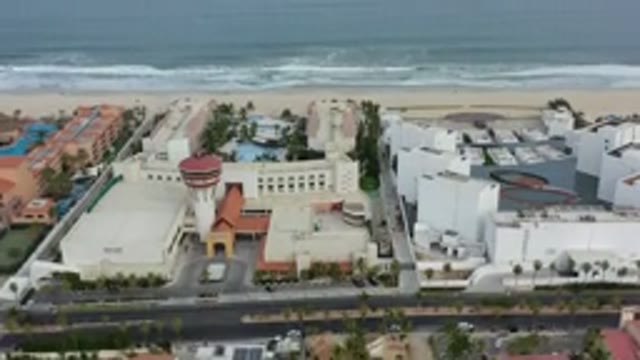 LOS CABOS MEXICO-2020: Camera Rising Over Beach, Sand, Sea, Buildings, and Horizon
