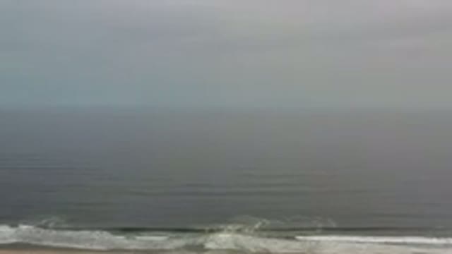LOS CABOS MEXICO-2020: Gently Rolling Ocean Waves On A Gray And Misty Day