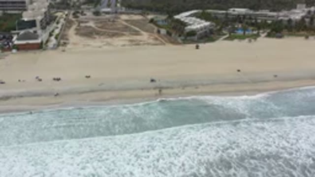 LOS CABOS MEXICO-2020: Gentle Waves With Foam On A Sunlit Beach