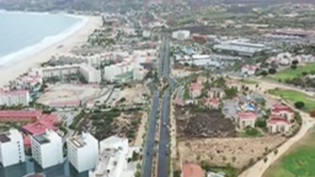 LOS CABOS MEXICO-2020: Buildings And Rooftop Of Beachfront City With Mountains