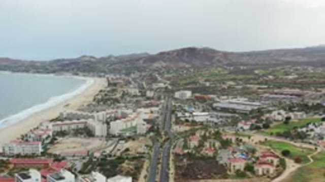 LOS CABOS MEXICO-2020: Aerial View Of City And Roadways Along A Beach With Mountains