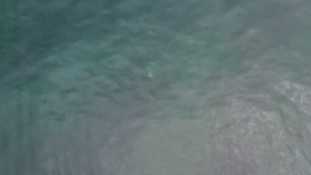 LOS CABOS MEXICO-2020: Ocean Waves With Sparkles And Faded Lights Under The