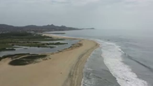 LOS CABOS MEXICO-2020: Footage Of A Beach Next To Mountains With Cloudy Sky In