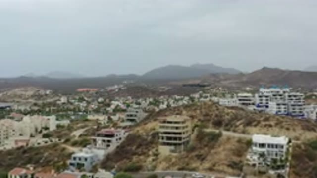 LOS CABOS MEXICO-2020: Overhead View Of City Buildings With Foggy Mountains In