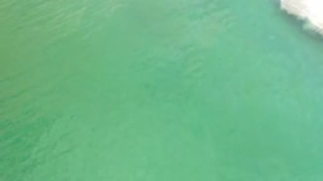 LOS CABOS MEXICO-2020: Green Water Flows Toward White Foam Backwash From Waves