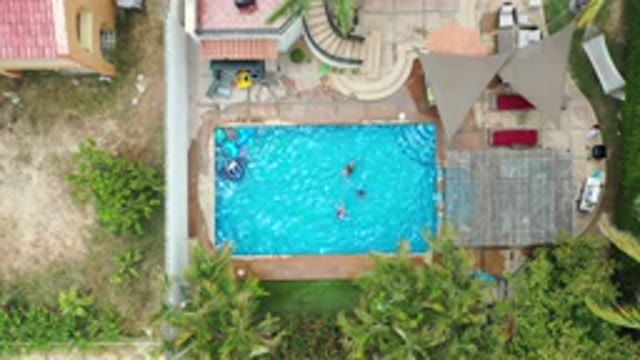 LOS CABOS MEXICO-2020: Three Persons Swimming in a Pool