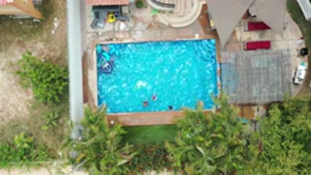 LOS CABOS MEXICO-2020: Kids Playing In The Swimming Pool While Their Dog Runs