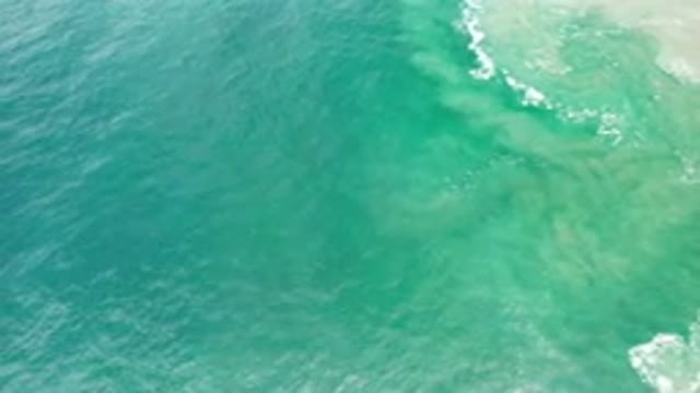 LOS CABOS MEXICO-2020: Green Ocean Water As Waves Ripple And Crash White Foam