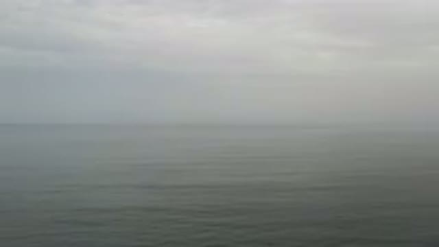 LOS CABOS MEXICO-2020: Aerial View Of Green Ocean Water With Hazy Cloudy Sky