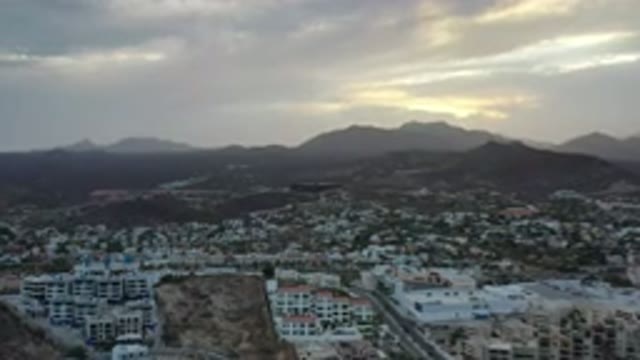 LOS CABOS MEXICO-2020: Sunset Backed Mountains Adjacent To Village From Birds