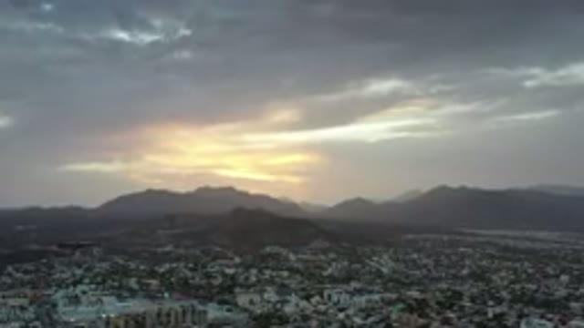 LOS CABOS MEXICO-2020: Cloudy Sunset Overlooking An Urban Sprawl Consisting