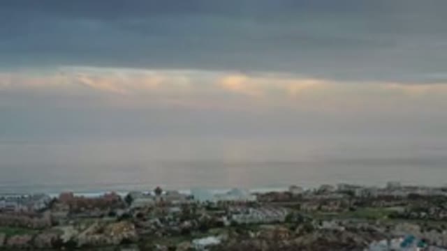 LOS CABOS MEXICO-2020: Sun Peep Through Clouds Over Beach Front Properties As