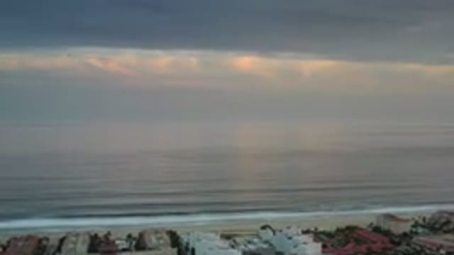 LOS CABOS MEXICO-2020: Multi-Color Clouds Create Haze Over Ocean Crashing