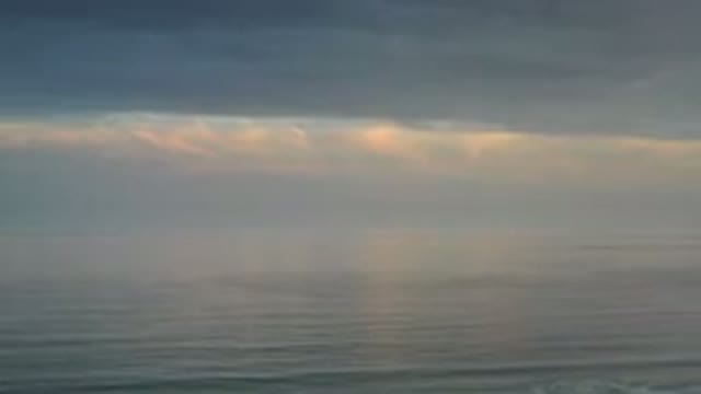 LOS CABOS MEXICO-2020: Dark Cloudy Gray Sky Over Peaceful Gray Ocean Water Waves